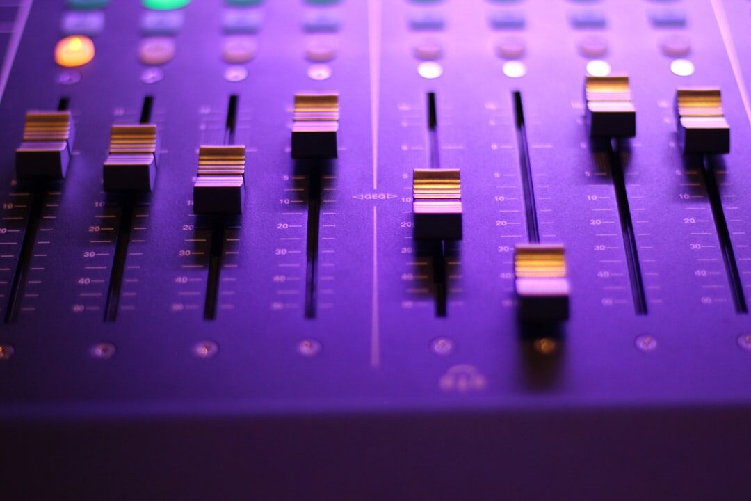 Audio mixing console with sliders for sound design