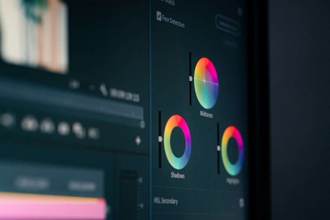 Dual-monitor video editing workstation showing a colour timeline